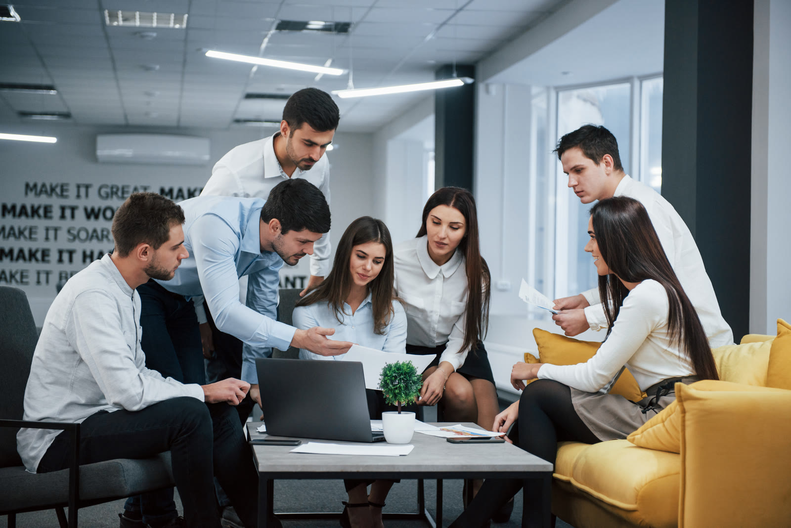 Eturia team collaborating around a laptop