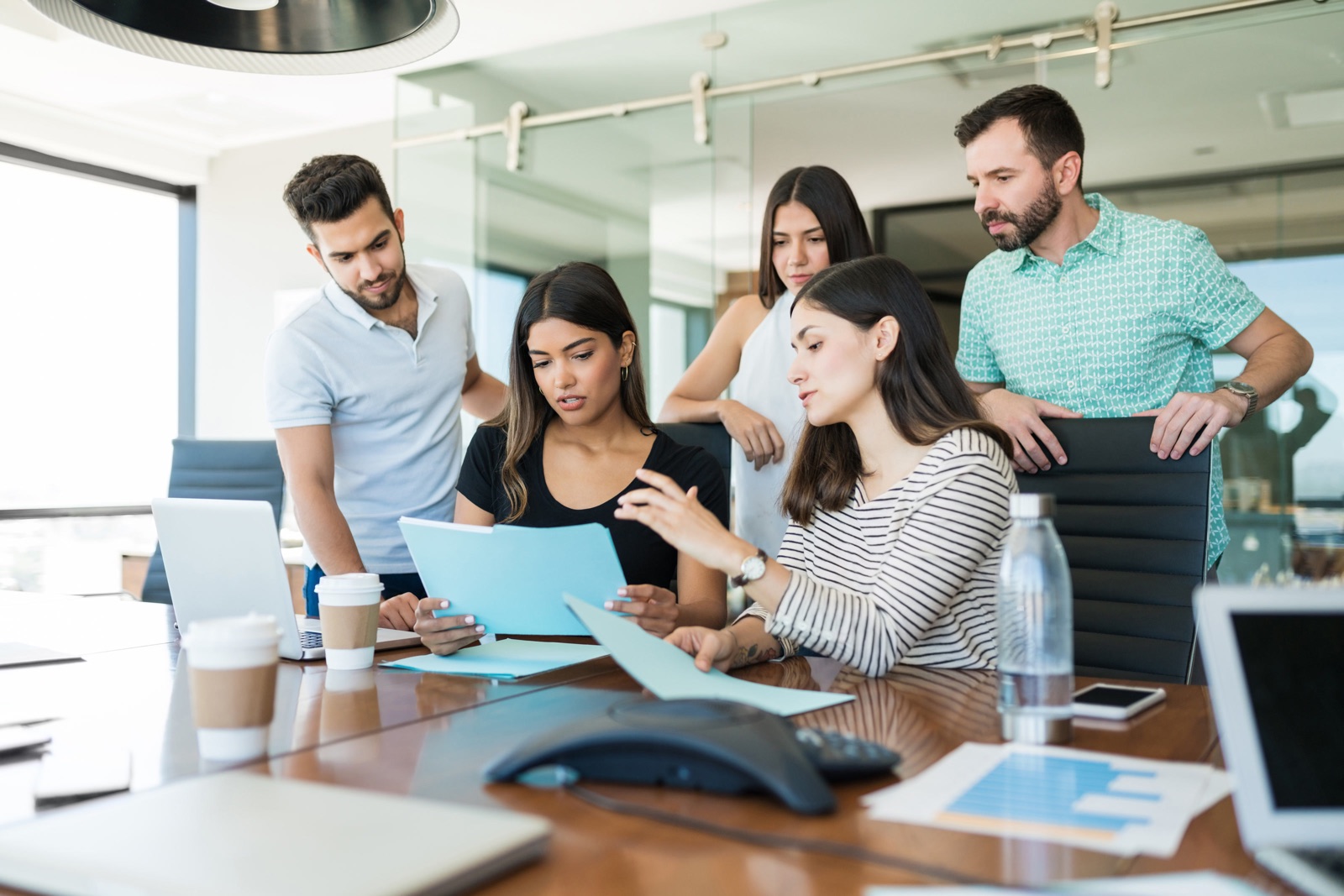 Eturia SAP Commerce consultants collaborating around a laptop